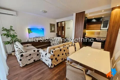 Living room with a dining area and an open view towards the kitchen. - image 2