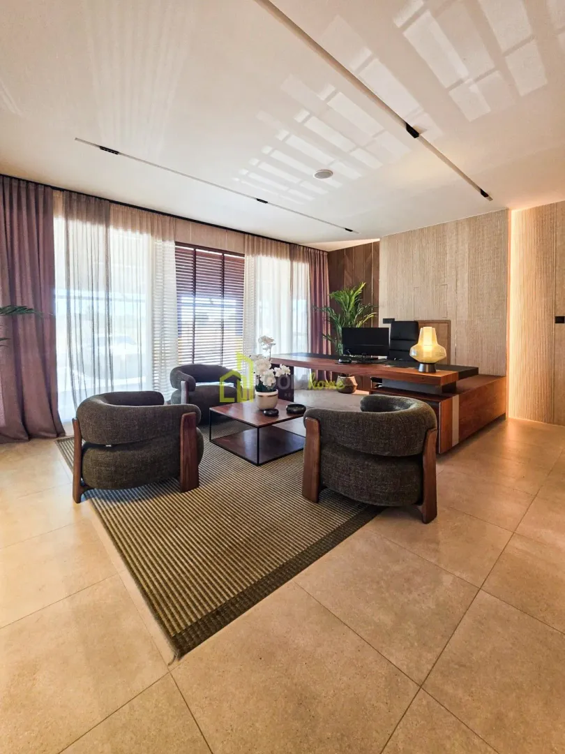 Modern living room with a seating area and a desk.