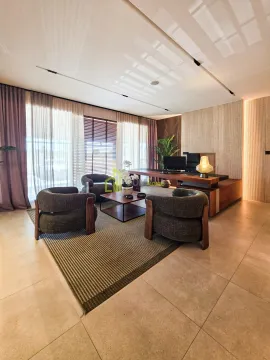 Modern living room with a seating area and a desk. - image 17