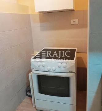 View of part of the kitchen with a stove and ceramic tiles. - image 4