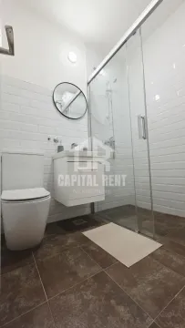 Modernly equipped bathroom with a walk-in shower and white sanitaryware. - image 10