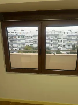 Pogled kroz prozor sa smeđim okvirom na susjednu zgradu. - image 10