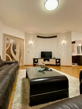 Spacious living room with a sofa, coffee table and TV. - image 2