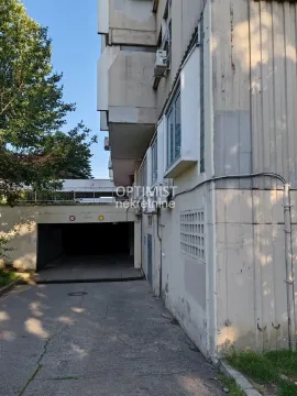 View of the driveway and entrance to the building's underground garage. - image 11
