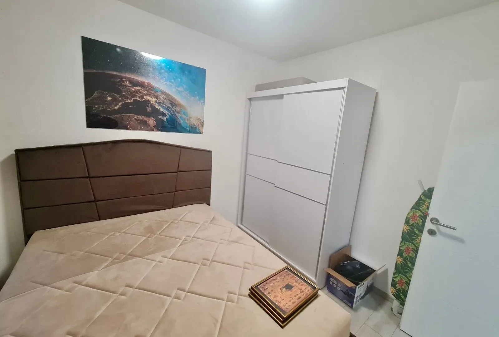 Furnished bedroom with a double bed and wardrobe.