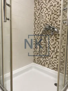 Shower enclosure with ceramic tiles and a faucet. - image 5