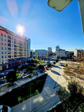 View from the terrace overlooking the city square and surrounding buildings. - image 14