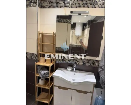 Bathroom with a sink, mirror, and wooden shelving unit. - image 13