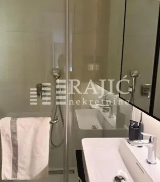 Modern bathroom with a sink and a shower cabin. - image 14
