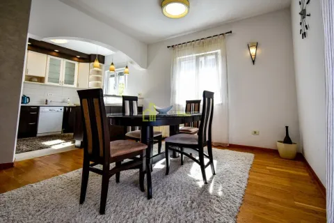 Dining area with a dining table and chairs, with a view of the kitchen. - image 9