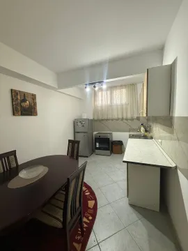 Kitchen with dining area and white cabinets. - image 6