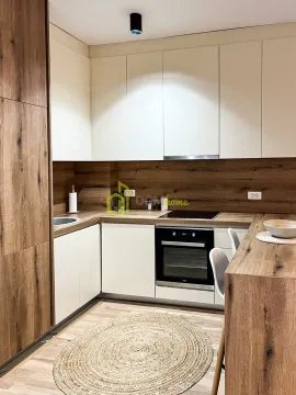 Modern kitchen with wooden elements and built-in appliances. - image 2