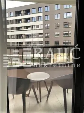 Furnished balcony with seating set and a view of neighboring buildings. - image 6