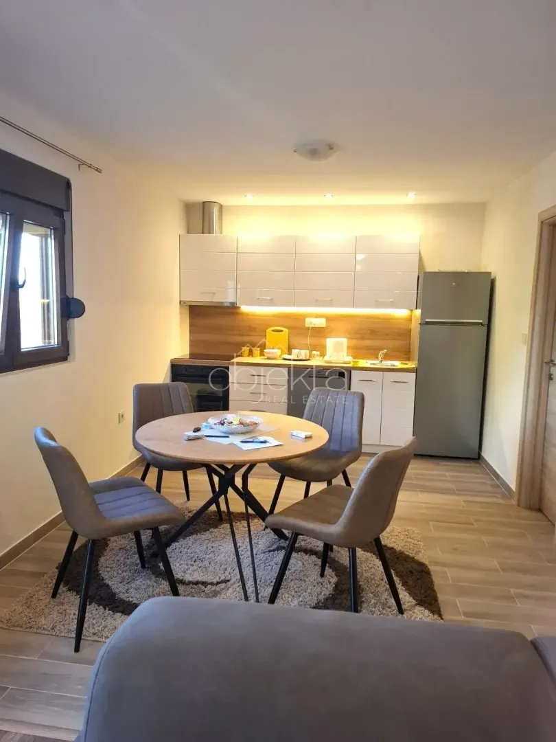 Kitchen with a dining area and modern cabinetry.