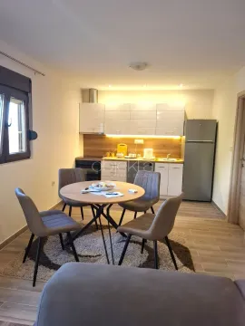Kitchen with a dining area and modern cabinetry. - image 10