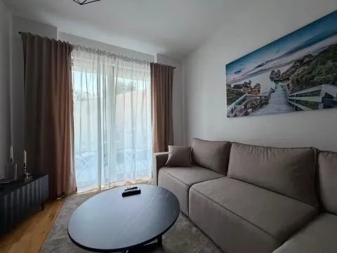 Living room with a comfortable sofa, coffee table and balcony doors. - image 5