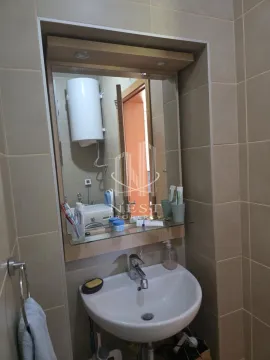 Bathroom with a washbasin, mirror and tiled walls. - image 7