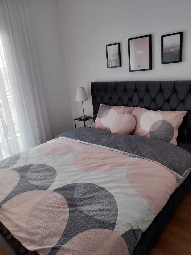 Bright bedroom with a modern double bed.