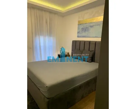 Furnished bedroom with a double bed and a window with curtains. - image 7