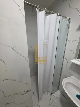 Modern bathroom with a shower cabin and marble tiles. - image 7