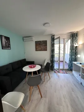 Living room with sofa, dining table, and access to the terrace. - image 3