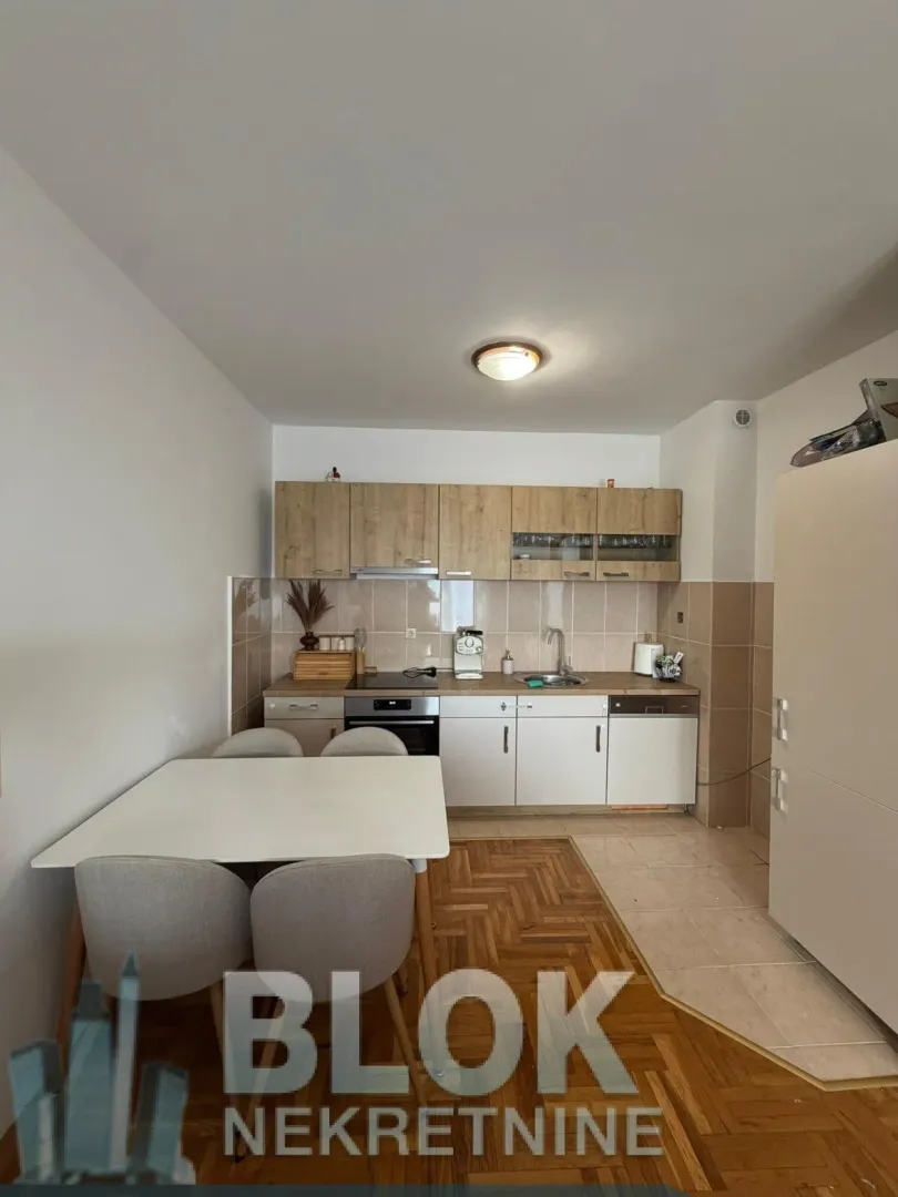Kitchen with a dining table and chairs.