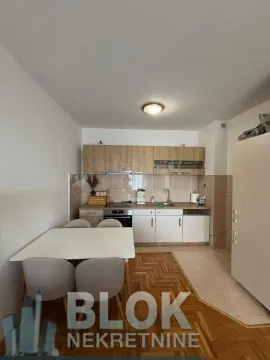 Kitchen with a dining table and chairs. - image 5