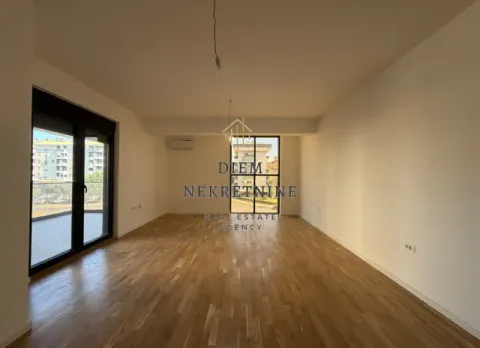 Empty living room with hardwood flooring and access to the terrace. - image 13
