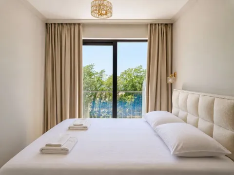 Comfortable bedroom with a large double bed and green views. - image 2