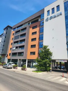 Exterior view of a modern residential building with commercial spaces on the ground floor. - image 26