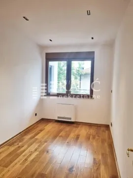 Empty room with wooden flooring and a window. - image 19