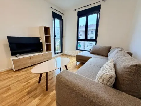 Living room with a sofa, TV, and access to the terrace. - image 2