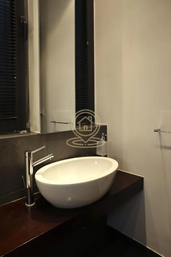 View of a washbasin with a faucet in a modern bathroom.