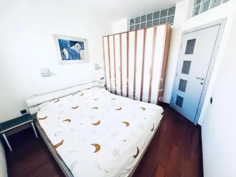 Bedroom with a double bed, large wardrobe, and white door. - image 12