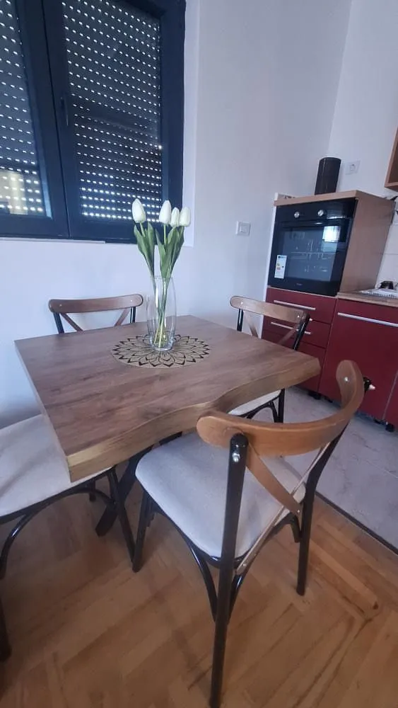 Dining table with chairs as part of the kitchen area.