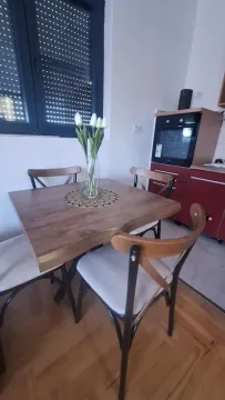 Dining table with chairs as part of the kitchen area. - image 12