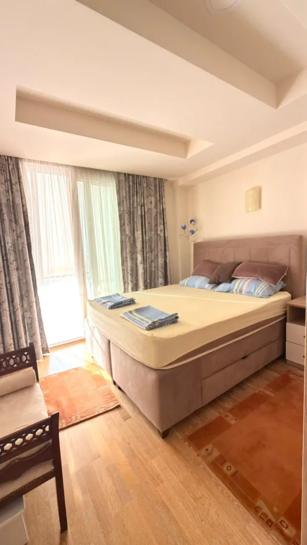 Spacious bedroom with a double bed and access to the balcony.