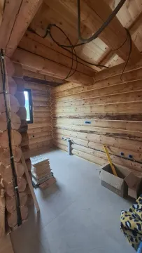 Interior of an unfinished wooden house with installations and floor tiles. - image 14