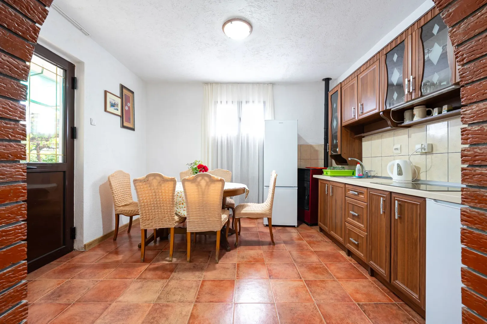 Kitchen with a dining area and wooden cabinetry.