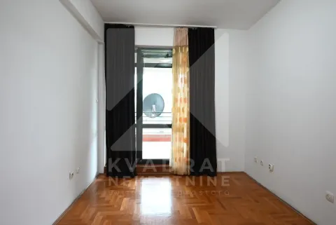 Empty room with parquet flooring and balcony doors with curtains. - image 6