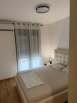 Furnished bedroom with a double bed and air conditioning. - image 7