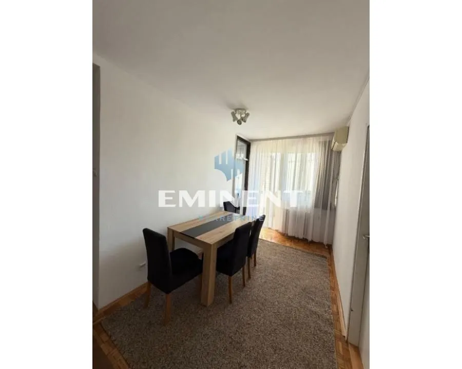 Dining area with a table and chairs in the living room.