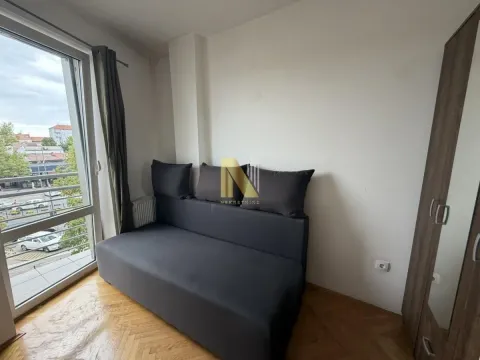 Small bedroom with a bed and a wardrobe next to the balcony door. - image 7