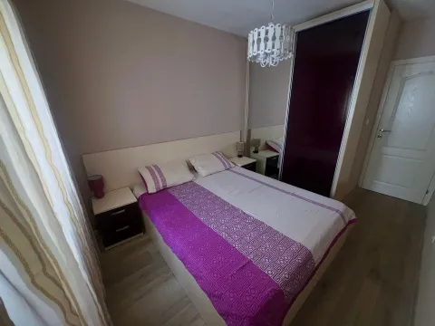 Bedroom with a double bed, bedside tables and a large wardrobe with a mirror. - image 4