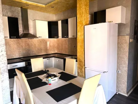 Kitchen with dining area and white cabinets. - image 3