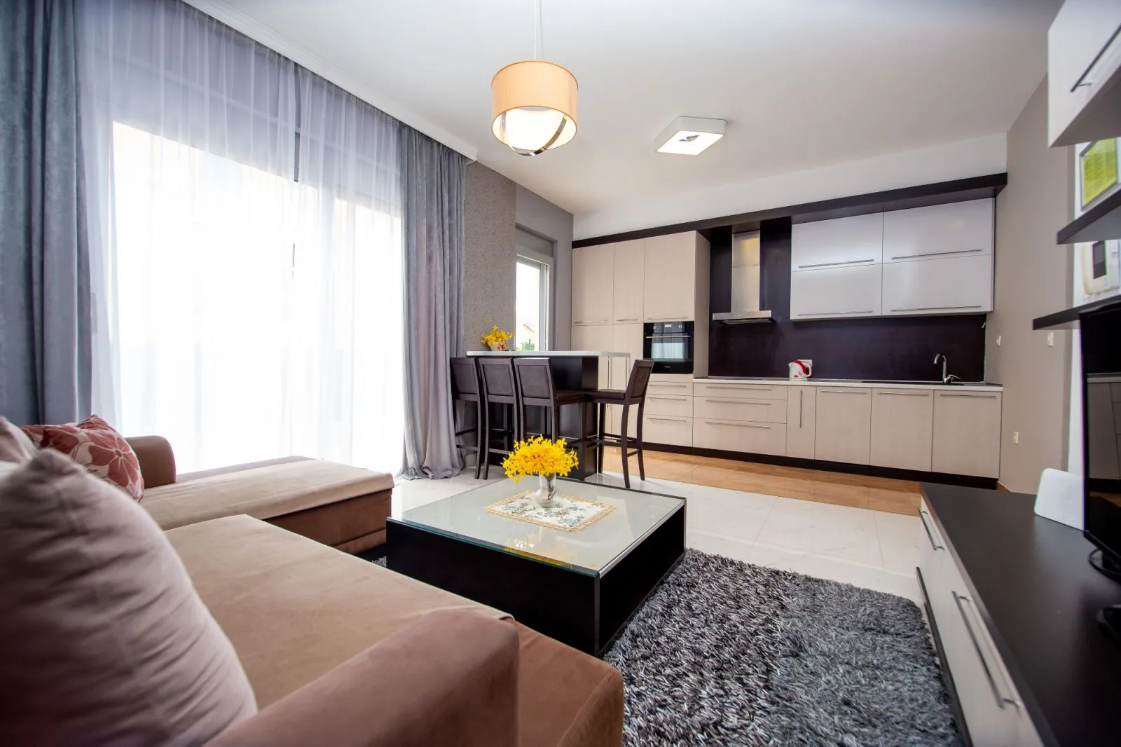 Spacious living room connected to the dining area and modern kitchen.