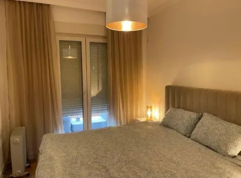 Furnished bedroom with a double bed and a window. - image 6
