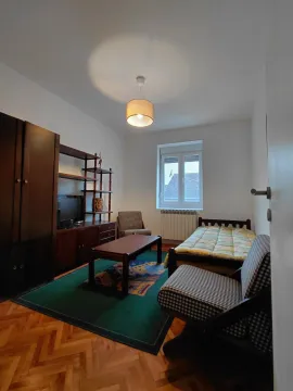 Furnished bedroom with a bed, wardrobe, and table. - image 11