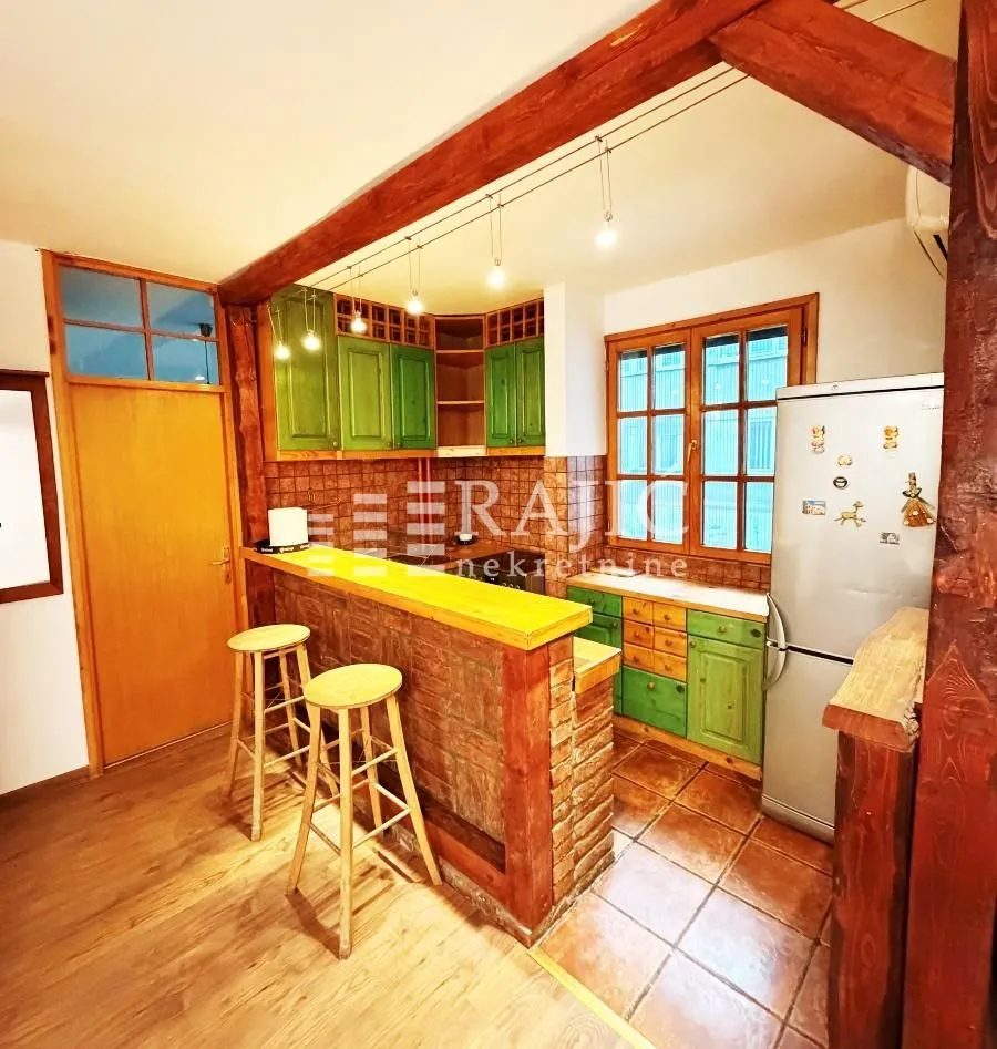 Rustic kitchen with a breakfast bar and wooden elements.