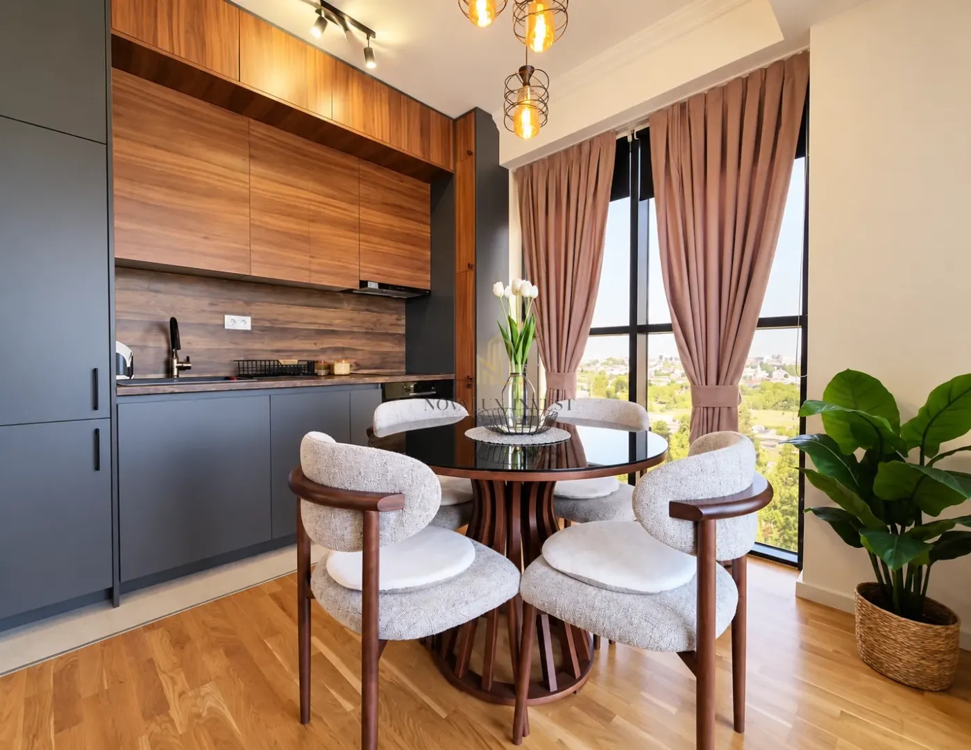 Modern kitchen with dining area and a large window.